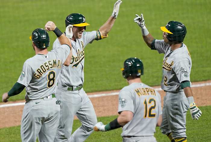 SAN FRANCISCO, CALIFORNIA - AUGUST 14: Stephen Piscotty #25, Khris Davis #2, Sean Murphy #12 and Robbie Grossman #8 of the Oakland Athletics celebrates after Piscotty hit a game tying grand slam against the San Francisco Giants in the top of the ninth inning at Oracle Park on August 14, 2020 in San Francisco, California.